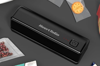 a black bag sealer machine next to packages of snacks