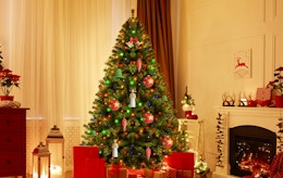 a pre-lit Christmas tree in a decorated room