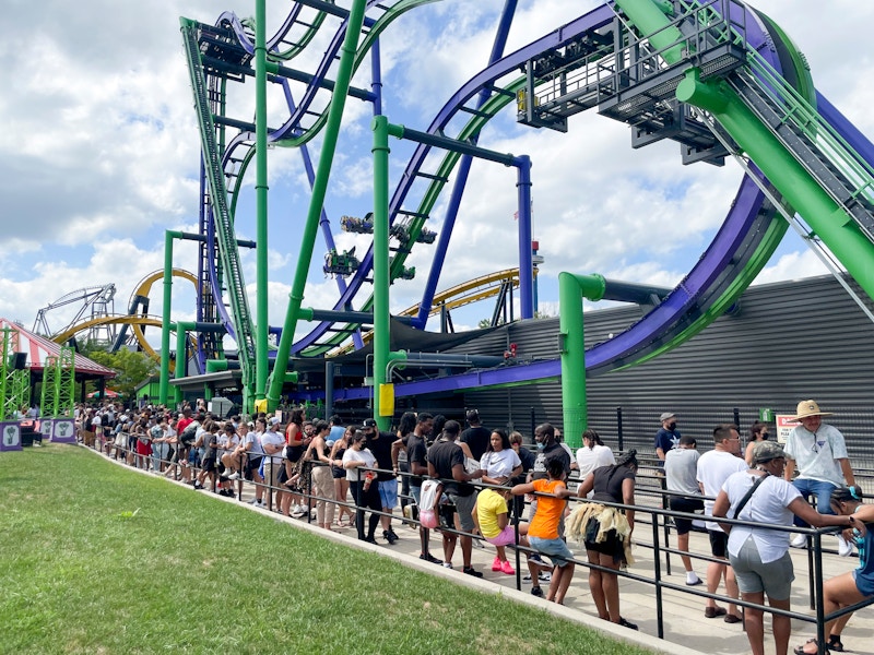 A line of people waiting to ride a roller coaster