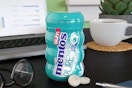 Mentos wintergreen gum on a computer desk.