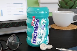 Mentos wintergreen gum on a computer desk.