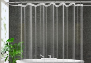 a Clear Peva Plastic Shower Curtain Liner hung up in front of a bathtub