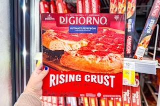 person holding a digiorno frozen pizza