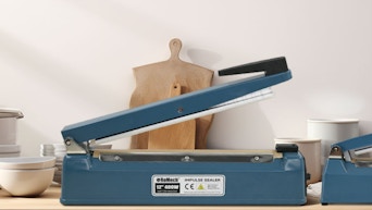 a blue heat sealer on a table in a kitchen 