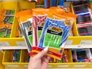 hand holding 3 packs of bic pens in front of a target shelf