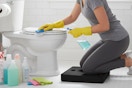 a woman kneeling while cleaning