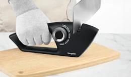 a person sharpening a knife 