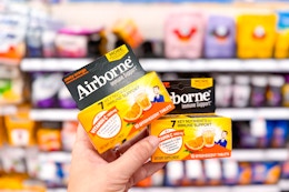hand holding 2 airborne immune support at target