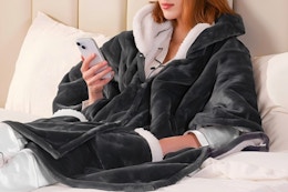 Women wearing a heated blanket in bed.