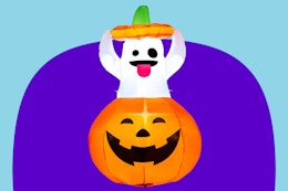 Inflatable Halloween ghost on a purple and blue background.