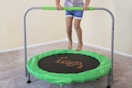 a girl jumping on a mini trampoline
