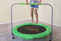 a girl jumping on a mini trampoline