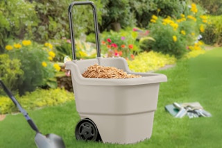 Lifestyle image of Suncast Utility Cart in outdoor setting with mulch inside cart
