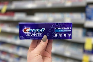 hand holding crest toothpaste
