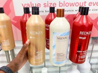 hand holding jumbo shampoo bottle