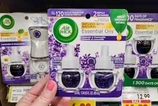 hand holding air wick scented oil refills at kroger