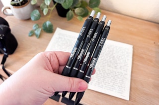 hand holding four sharpie s gel pens