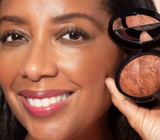 a woman holding a bronzer