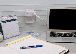 outlet extender with a laptop behind a desk