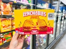 hand holding lunchables grilled cheesies at walmart
