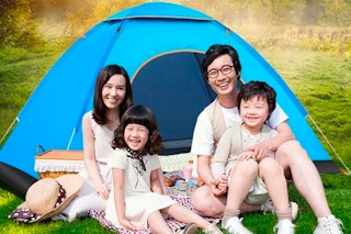 a family sitting outside of the Personal Travel 3-Person Pop-up Tent outdoors