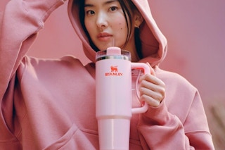 a woman using a stanley tumbler