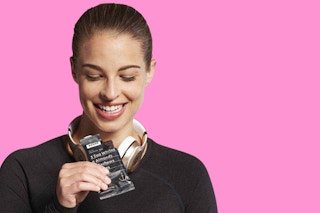 a woman eating a chocolate sea salt rxbar