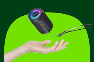 A hand throws a 5-inch cylindrical bluetooth speaker with RGB lights and lanyard into the air.