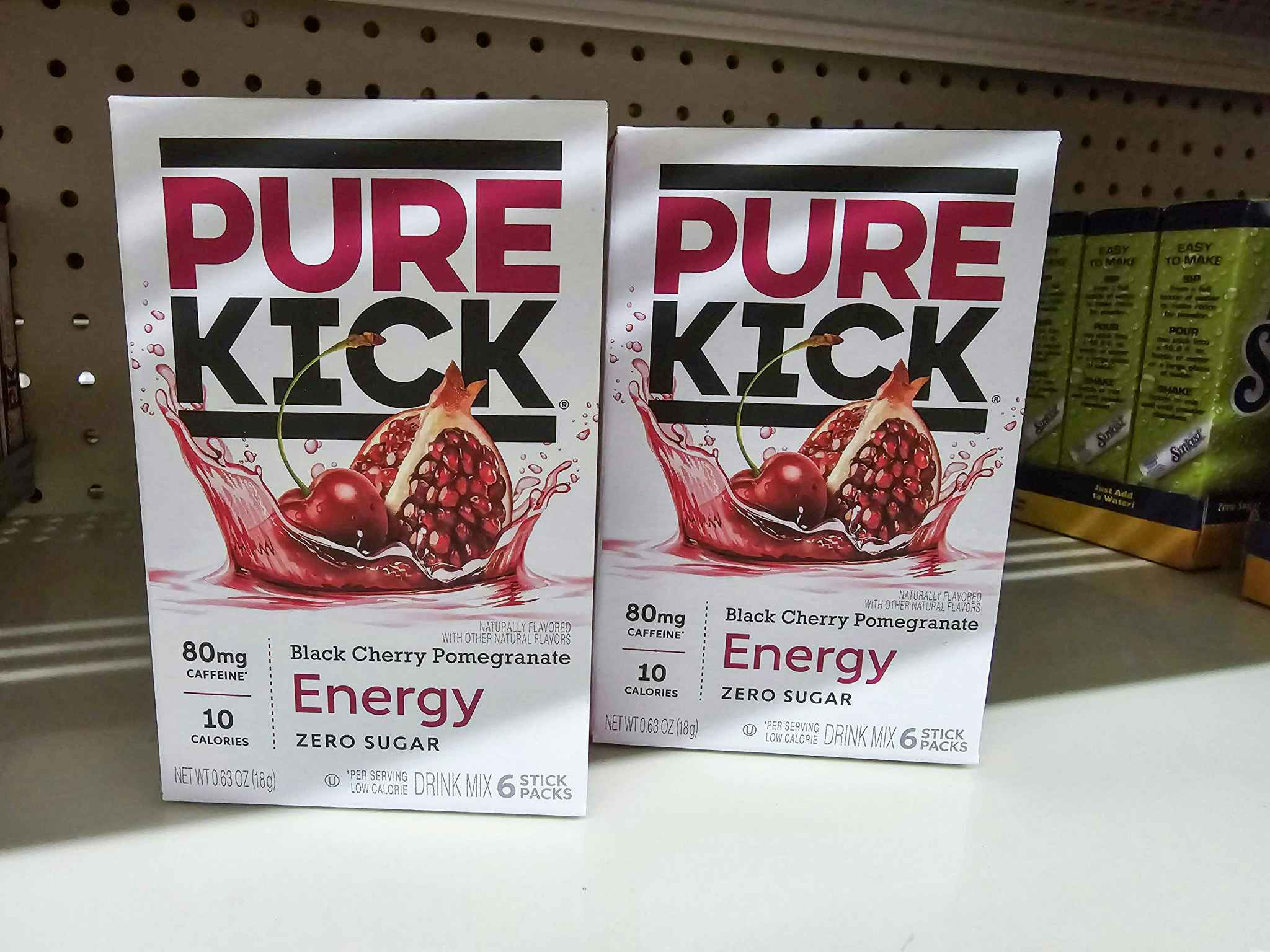 boxes of pure kick hydration singles on a shelf