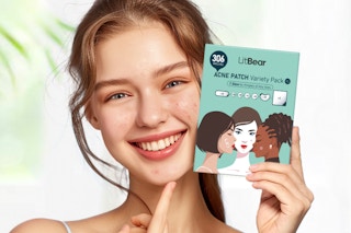 a girl holding up a pack of Large Pimple Patches, 306 ct