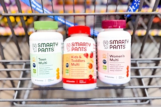 green, red, and maroon bottles of SmartPants vitamins in a Walmart cart