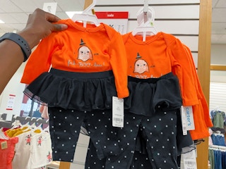 hand holding carters halloween outfit set