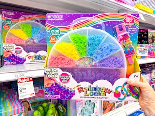 hand holding a rainbow loom set in front of a target shelf