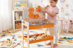 child playing with the Hape tool bench