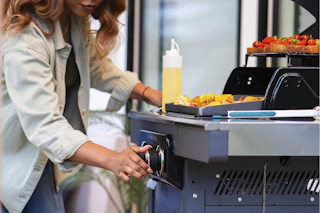 a woman using a grill