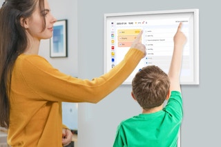 a woman and child using a digital calendar