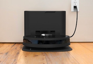 self-emptying robotic vacuum plugged into outlet