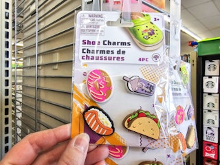 person holding a 4-pack of shoe charms