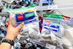 hand grabbing a hanes kids socks 12-pair pack off a target shelf