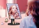 a person looking into a LED makeup mirror