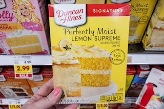 hand holding a box of duncan hines cake mix at kroger