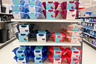 A variety of blue and red tupperware bowls on the endcap shelf at target