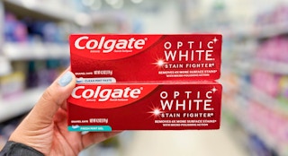 someone holding colgate toothpaste at walgreens