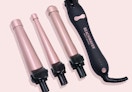 a pink curling iron with attachments
