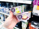 hand holding dannon yogurts