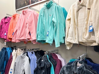 A variety of Columbia jackets hanging in a Kohls