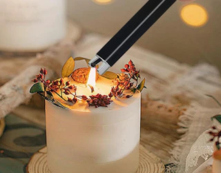 a lighter lighting a candle