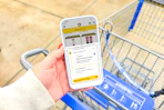 hand holding a smartphone displaying a 1-clip coupon deal in the kcl app