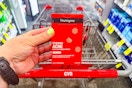 person holding a box of neutrogena acne blemish patches over a cvs cart