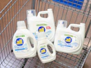 4 all laundry detergent bottles sitting in a walmart cart